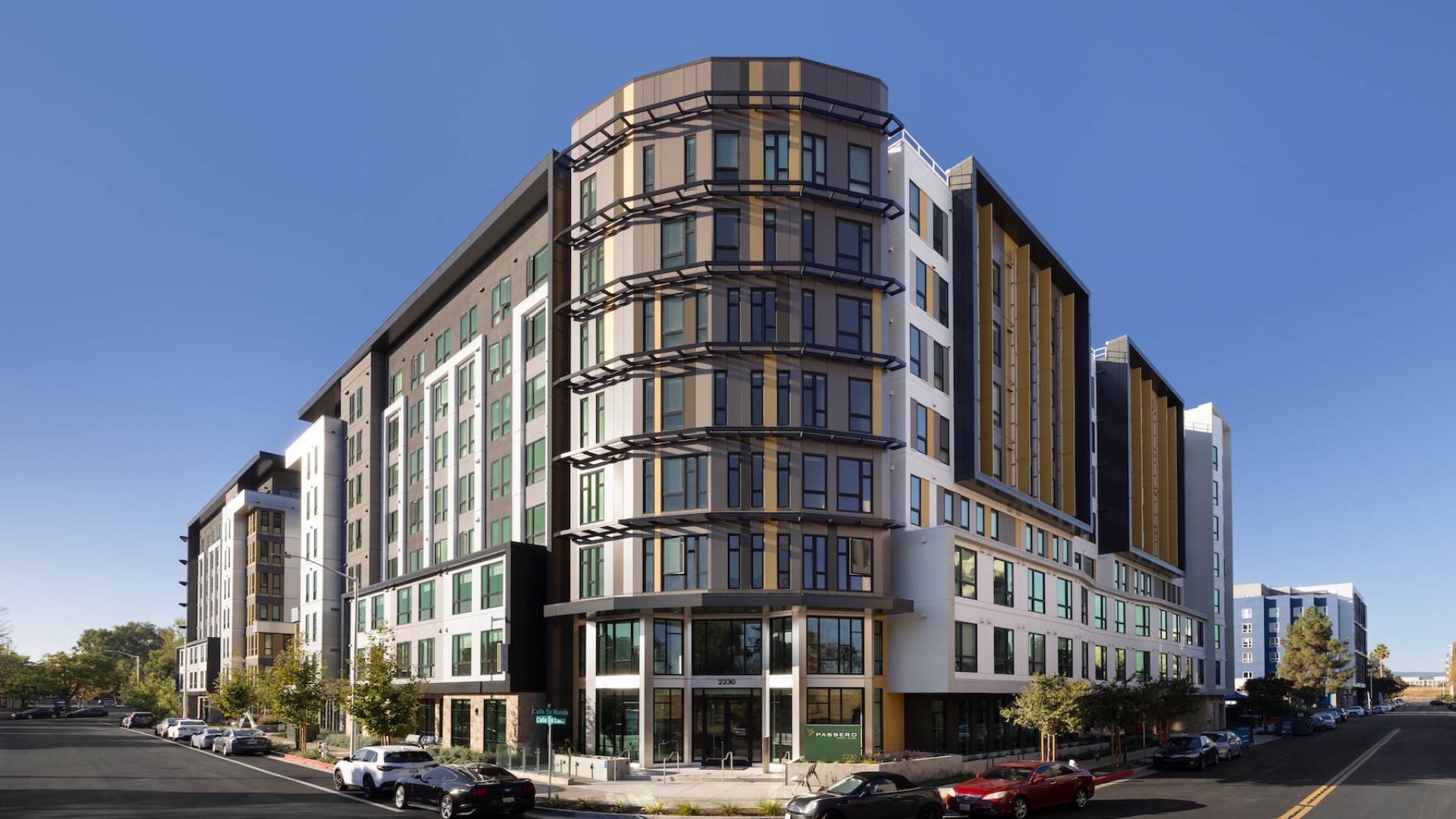 the front of a large building with cars