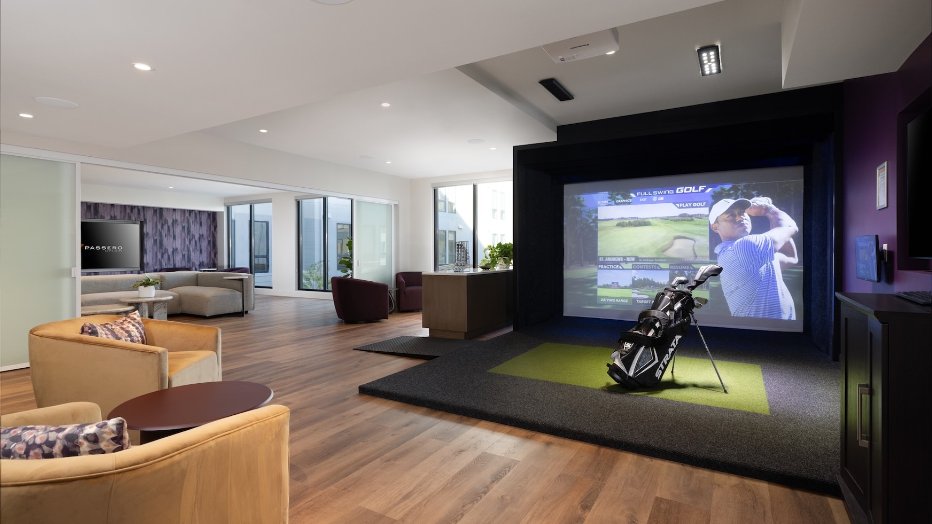 a clubroom with a golf simulator