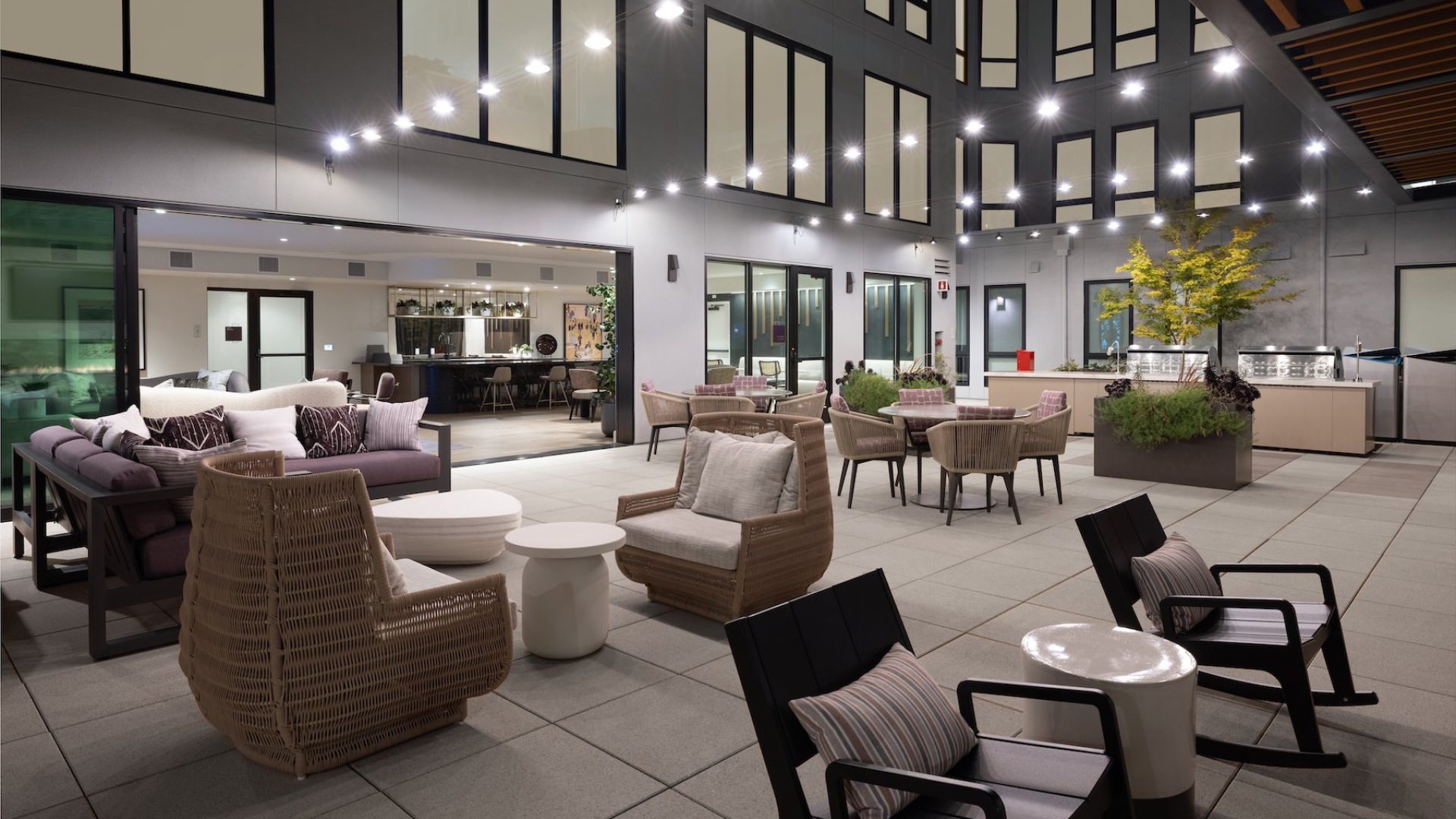 a patio area with couches, tables and chairs