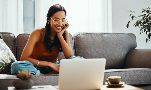 Person sitting in front of her computer smiling