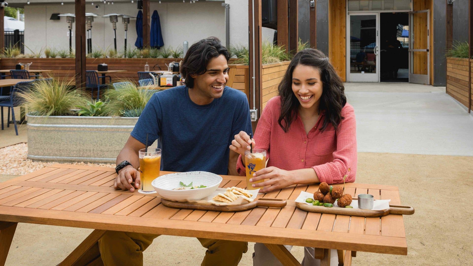 Couple sitting at a table eating 