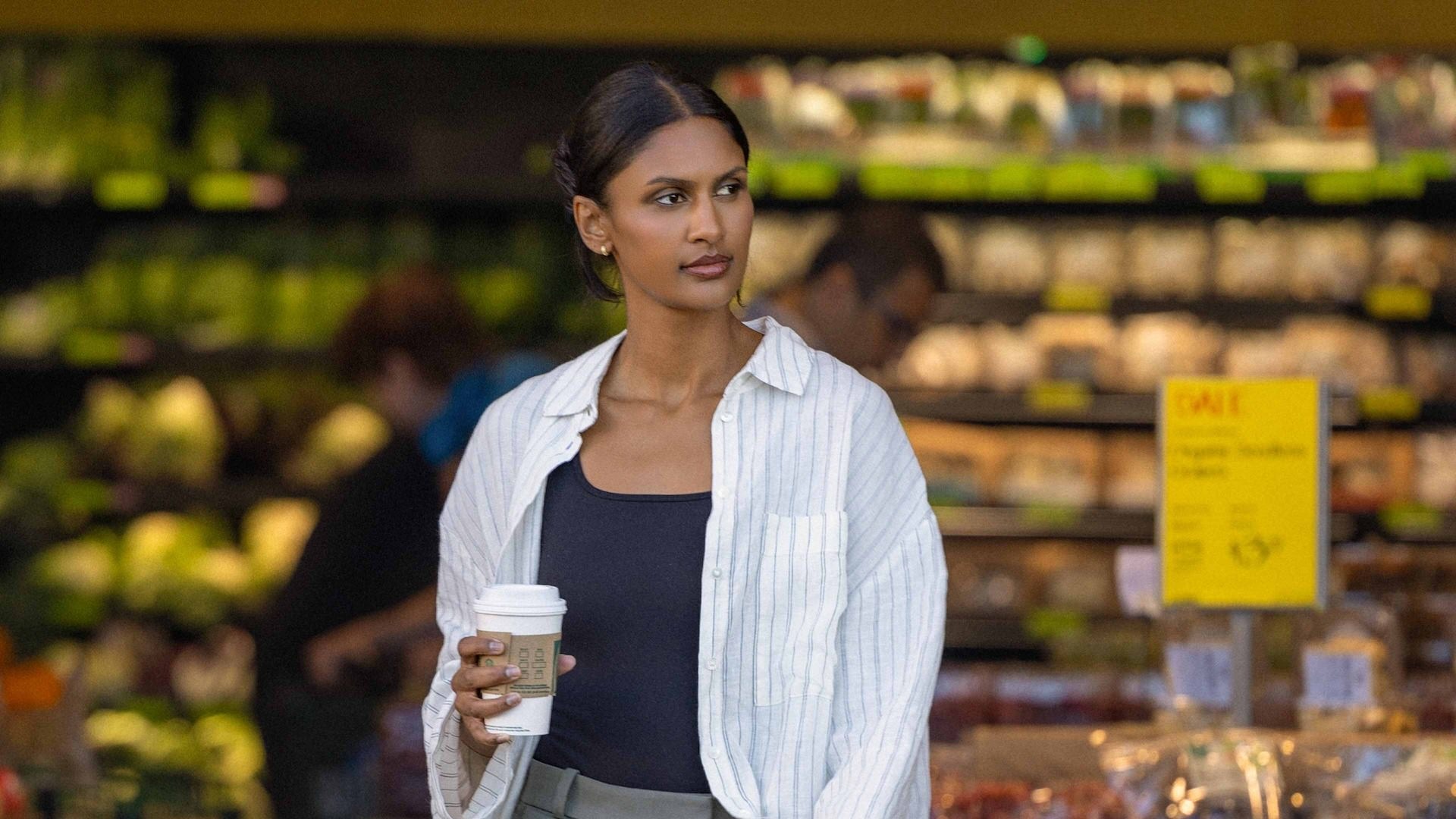 Woman walking out of a produce shop